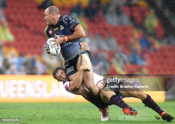 Matthew Scott of the Cowboys attempts to break through the defence during the NRL trial match and Jonathan Thurston/Cameron Smith Testimonial match...