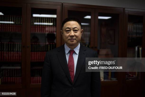 Chinese billionaire Hu Keqin poses in his headquarters in Beijing on January 30, 2018. - Interested in the French wheat, Hu Keqin bought farms in...