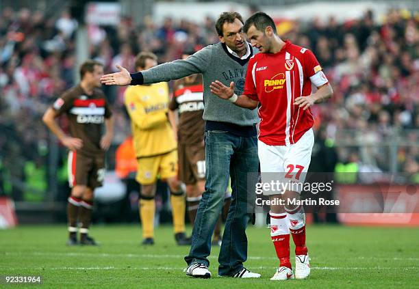 Claus Dieter Wollitz , head coach of Cottbus argues with Ovidiu Burca of Cottbus after the Second Bundesliga match between FC St. Pauli and Energie...