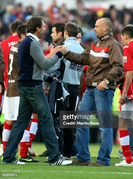 Holger Stanislawski , head coach of St. Pauli and Claus Dieter Wollitz , head coach of Cottbus shake hands after the Second Bundesliga match between...