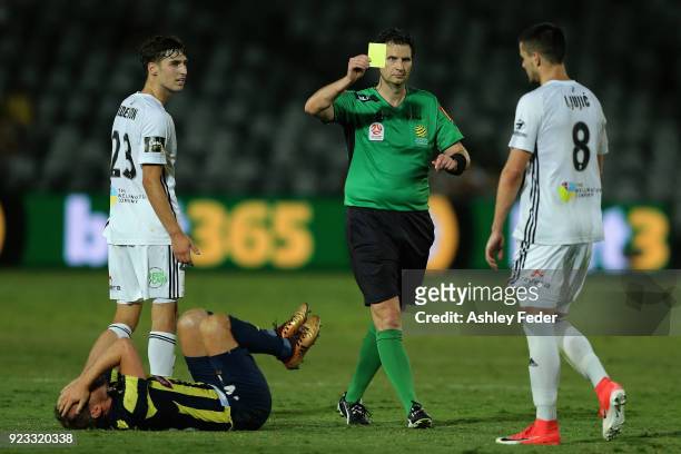 Referee Kris Griffith-Jones shows a yellow card to Matija Ljujic of the Phoenix for a foul against Wout Brama of the Mariners during the round 21...
