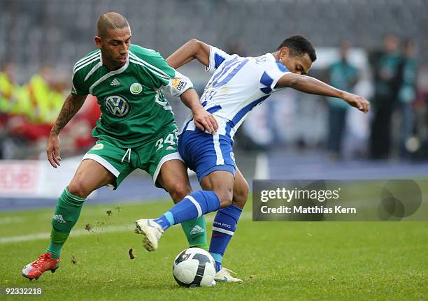 Ashkan Dejagah of Wolfsburg battles for the ball with Raffael of Berlin during the Bundesliga match between Hertha BSC Berlin and VFL Wolfsburg at...