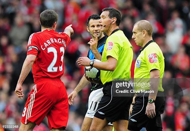 Jamie Carragher of Liverpool and Ryan Giggs of Manchester United have words with Referee Andre Marriner during the Barclays Premier League match...