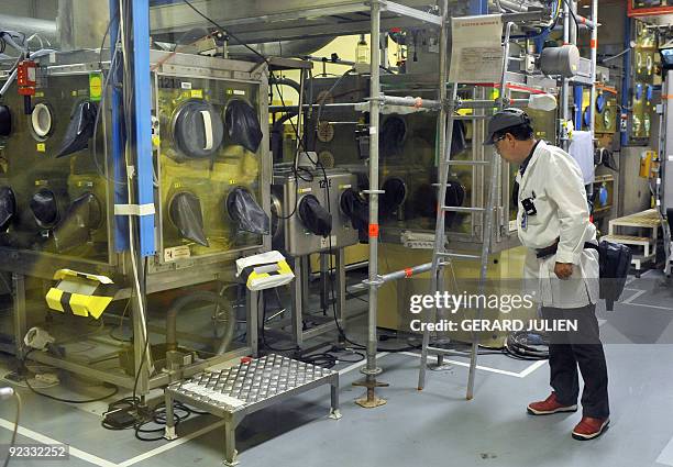 Technician of the French Atomic Energy Commission is pictured in the "atelier de technologie du plutonium" at the Cadarache nuclear research centre...