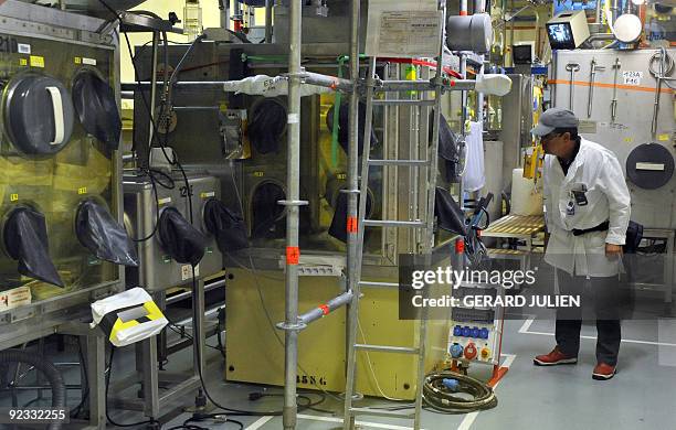 Technician of the French Atomic Energy Commission is pictured in the "atelier de technologie du plutonium" at the Cadarache nuclear research centre...