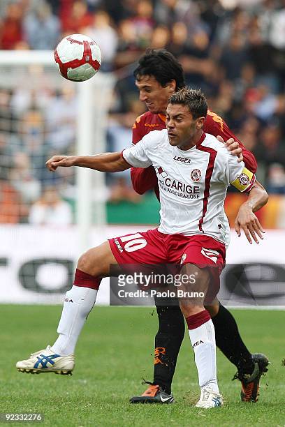 Francesco Tavano of Livorno Calcio and Nicolas Burdisso of AS Roma compete for the ball during the Serie A match between Roma and Livorno Calcio at...