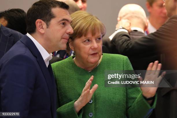 Greece's Prime Minister Alexis Tsipras and Germany's Chancellor Angela Merkel speak as they attend an informal meeting of the 27 EU heads of state or...