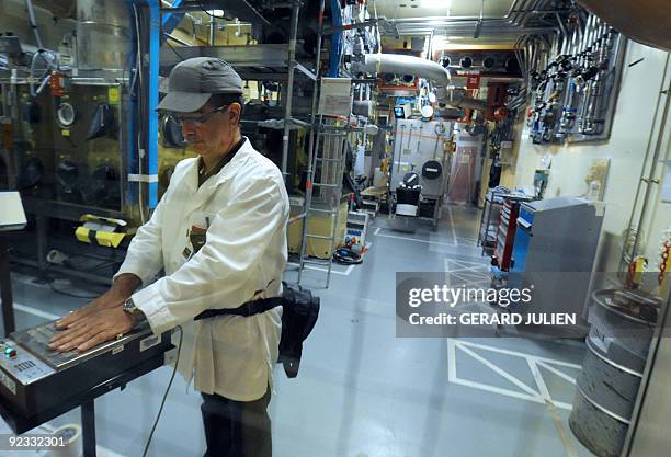 Technician of the French Atomic Energy Commission checks his radioactivity rate before leaving the "atelier de technologie du plutonium" at the...
