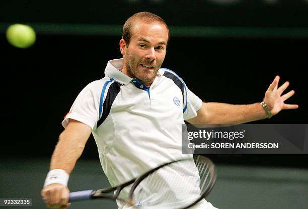 Olivier Rochus of Belgium returns the ball to Marcos Baghdatis of Cyprus on October 25, 2009 in the final of the Stockholm Open in the Swedish...