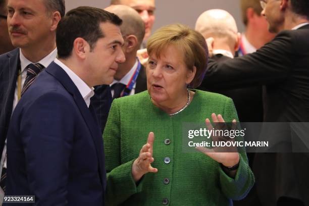 Greece's Prime Minister Alexis Tsipras and Germany's Chancellor Angela Merkel speak as they attend an informal meeting of the 27 EU heads of state or...