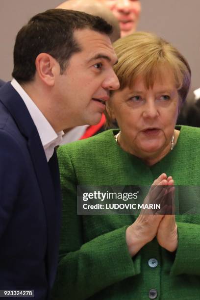 Greece's Prime Minister Alexis Tsipras and Germany's Chancellor Angela Merkel speak as they attend an informal meeting of the 27 EU heads of state or...