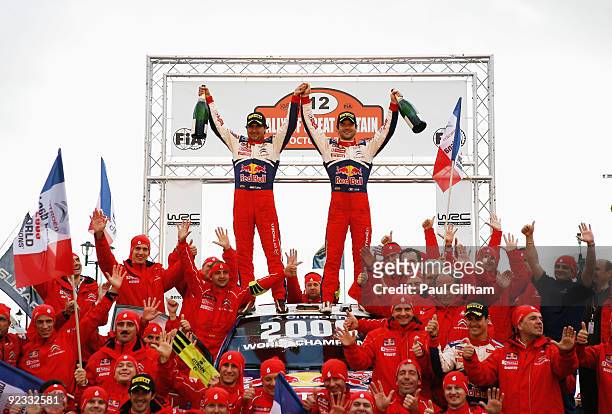 Sebastien Loeb of France and Citroen Total WRT and his co-driver Daniel Elena celebrate on the Citroen C4 WRC alongside the Citroen Total WRT Team...