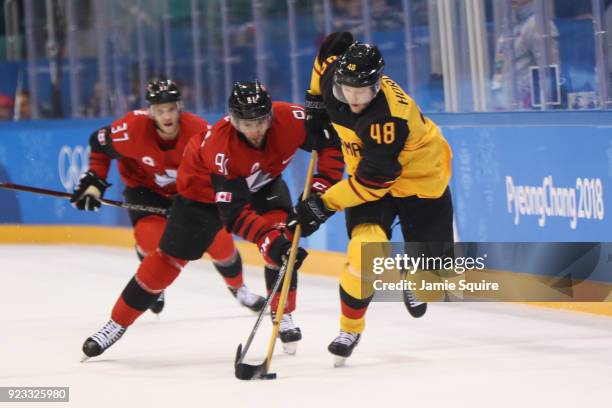 Frank Hordler of Germany controls the puck against Linden Vey of Canada in the first period during the Men's Play-offs Semifinals on day fourteen of...