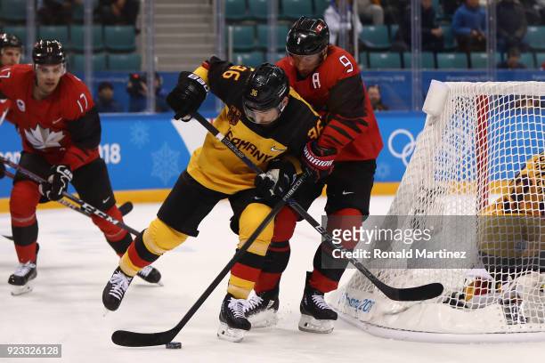 Yannic Seidenberg of Germany controls the puck against Derek Roy of Canada in the first period during the Men's Play-offs Semifinals on day fourteen...