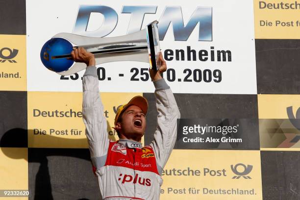 Audi driver Timo Scheider of Germany celebrates after winning the overall competition of the DTM 2009 German Touring Car Championship at the...