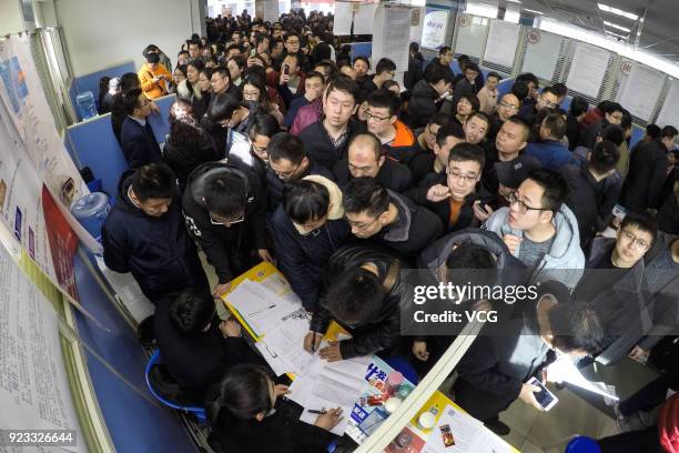 Job seekers crowd to a job fair on February 23, 2018 in Taiyuan, Shanxi Province of China. Companies showcase their job offerings for job seekers in...