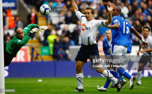 KevinDavies of Bolton Wanderers is closed down by Tim Howard and Sylvain Distin of Everton during the Barclays Premier League match between Bolton...