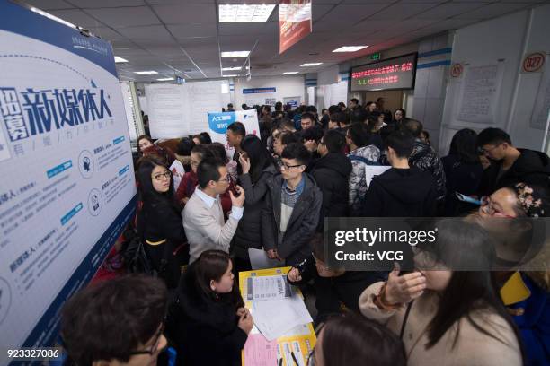 Job seekers crowd to a job fair on February 23, 2018 in Taiyuan, Shanxi Province of China. Companies showcase their job offerings for job seekers in...