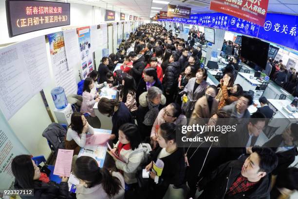 Job seekers crowd to a job fair on February 23, 2018 in Taiyuan, Shanxi Province of China. Companies showcase their job offerings for job seekers in...