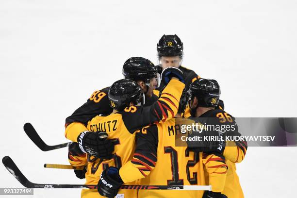 Germany's Brooks Macek is congratulated by teammates after scoring in the men's semi-final ice hockey match between Canada and Germany during the...