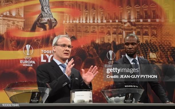 Director of competitions Giorgio Marchetti speaks next to Barcelona and Lyon's former player Eric Abidal during the draw for the round of 16 of the...
