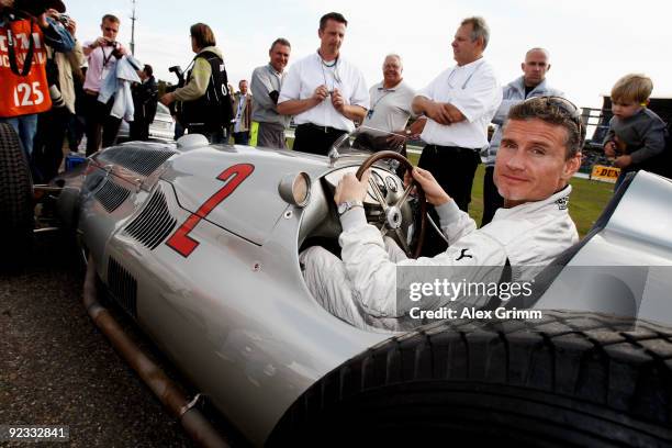 Former Formula One driver David Coulthard of Scotland poses in a Mercedes oldtimer racing car before the final run of the DTM 2009 German Touring Car...