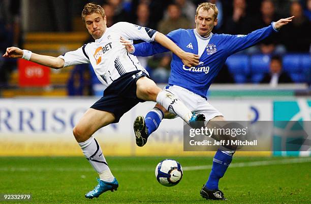 Ivan Klasnic of Bolton Wanderers tackles Tony Hibbert of Everton during the Barclays Premier League match between Bolton Wanderers and Everton at...