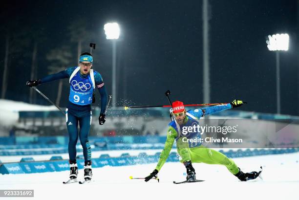 Dmytro Pidruchnyi of Ukraine and Lenart Oblak of Slovenia lunge for the finish line during the Men's 4x7.5km Biathlon Relay on day 14 of the...