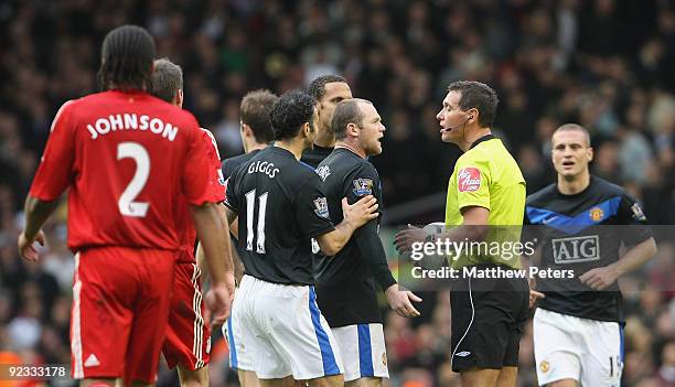 Wayne Rooney of Manchester United complains to referee Andre Marriner during the FA Barclays Premier League match between Liverpool and Manchester...