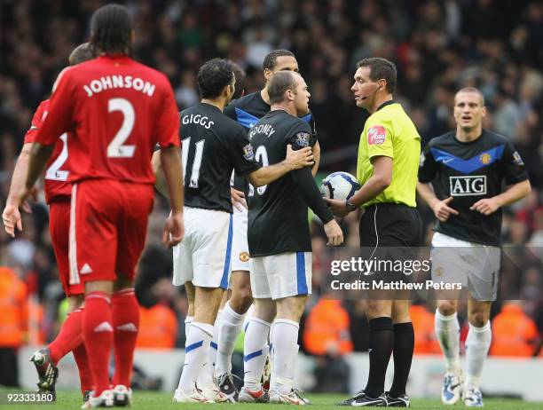 Wayne Rooney of Manchester United complains to referee Andre Marriner during the FA Barclays Premier League match between Liverpool and Manchester...