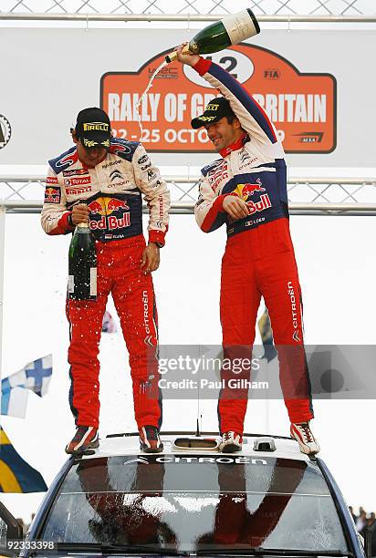 Sebastien Loeb of France and Citroen Total WRT and his co-driver Daniel Elena celebrate on the Citroen C4 WRC after winning the World Championship...