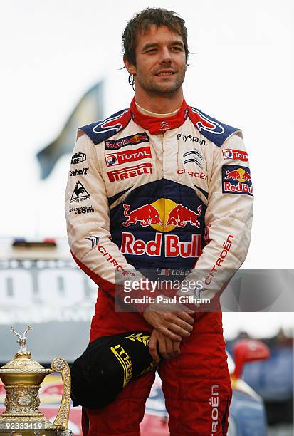 Sebastien Loeb of France and Citroen Total WRT looks on after winning the World Championship and the Wales Rally GB at Cardiff Bay on October 25,...