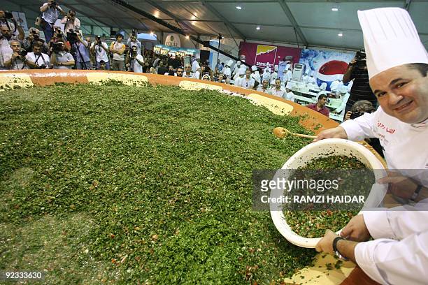 Lebanon's famous chef Ramzi Choueiry helps prepare a giant tabbouleh salad to set a new world record in Beirut on October 25, 2009. While Lebanon may...