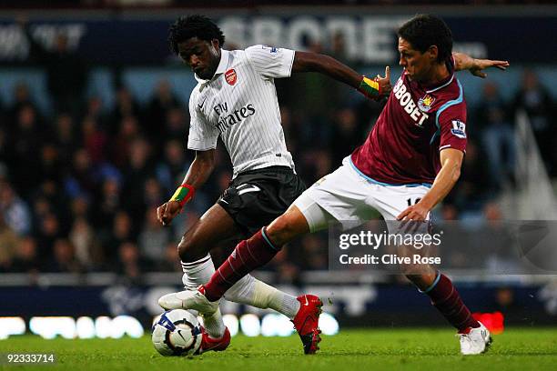 Alexandre Song of Arsenal battles for the ball with Guillermo Franco of West Ham United during the Barclays Premier League match between West Ham...