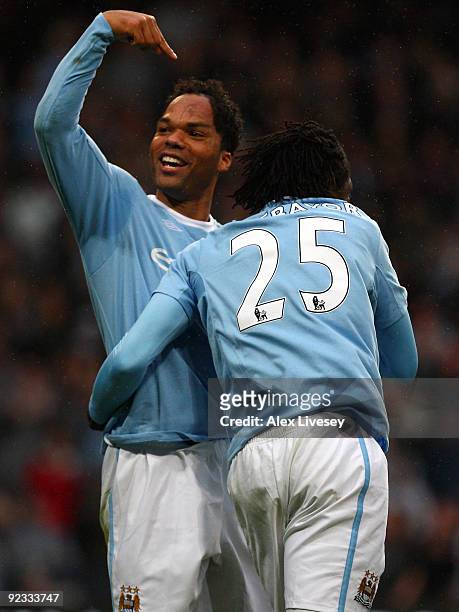 Joleon Lescott of Manchester City celebrates with Emmanuel Adebayor after scoring the opening goal during the Barclays Premier League match between...