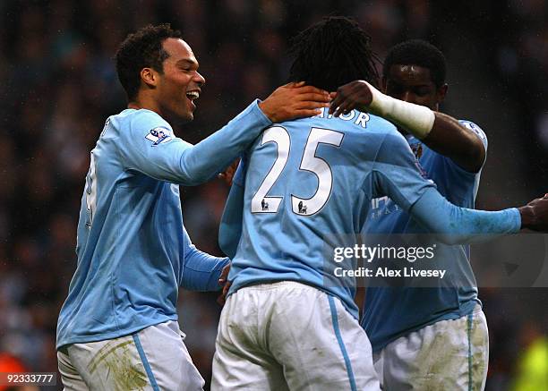 Joleon Lescott of Manchester City celebrates with Emmanuel Adebayor after scoring the opening goal during the Barclays Premier League match between...