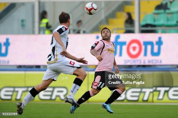 Andrea Coda of Udinese and Fabrizio Miccoli of Palermo compete for the ball during the Serie A match between US Citta di Palermo and Udinese Calcio...