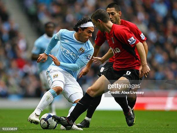Carlos Tevez of Manchester City turns away from Chris Baird of Fulham during the Barclays Premier League match between Manchester City and Fulham at...