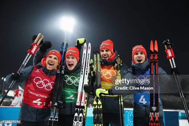 Erik Lesser, Benedikt Doll, Arnd Peiffer and Simon Schempp of Germany celebrate winning the bronze medal during the victory ceremony for the Men's...