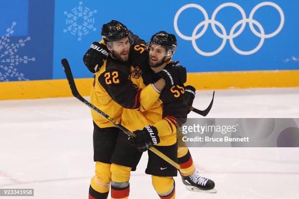 Matthias Plachta of Germany celebrates with Felix Schutz after scoring in the second period against Canada during the Men's Play-offs Semifinals on...