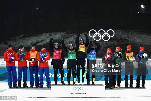 Silver medallists Lars Helge Birkeland, Tarjei Boe, Johannes Thingnes Boe and Emil Hegle Svendsen of Norway pose with gold medallists Peppe Femling,...