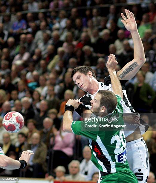 Kim Andersson of Kiel challenges for the ball with Rares Jurca of Goeppingen during the Toyota Handball Bundesliga match between THW Kiel and Frisch...