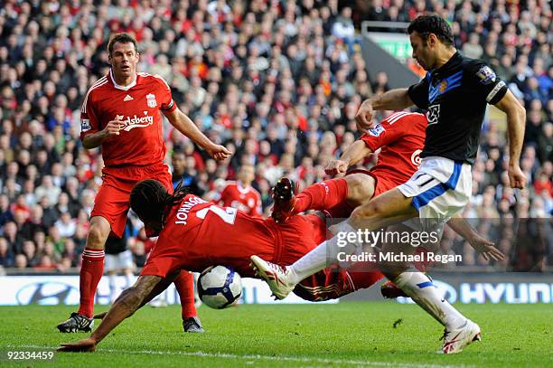 Glen Johnson of Liverpool blocks the shot of Ryan Giggs of Manchester United during the Barclays Premier League match between Liverpool and...