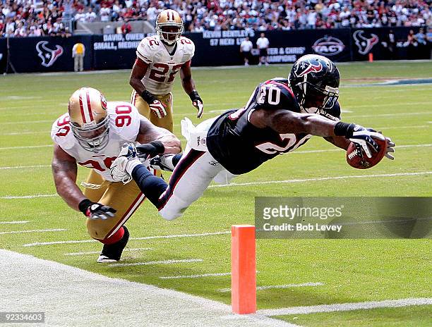 Running back Steve Slaton of the Houston Texans dives for a touchdown in the second quarter as defensive tackle Isaac Sopoaga of the San Francisci...