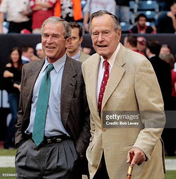 Former US Presidents' George W. Bush and George H.W. Bush walk the sidelines before the game between the San Francisco 49ers and Houston Texans at...
