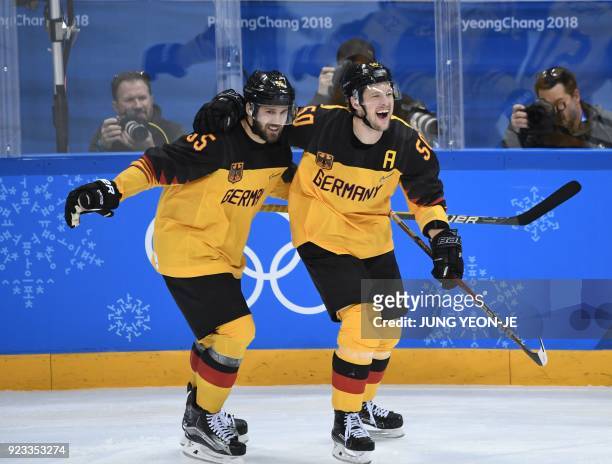 Germany's Felix Schutz and Germany's Patrick Hager celebrate a goal in the men's semi-final ice hockey match between Canada and Germany during the...