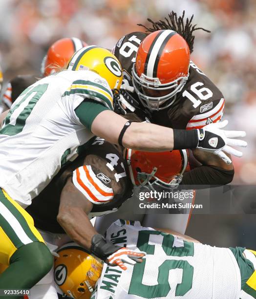 Joshua Cribbs of the Cleveland Browns is hit by A.J. Hawk and Clay Matthews of the Green Bay Packers at Cleveland Browns at Cleveland Browns Stadium...