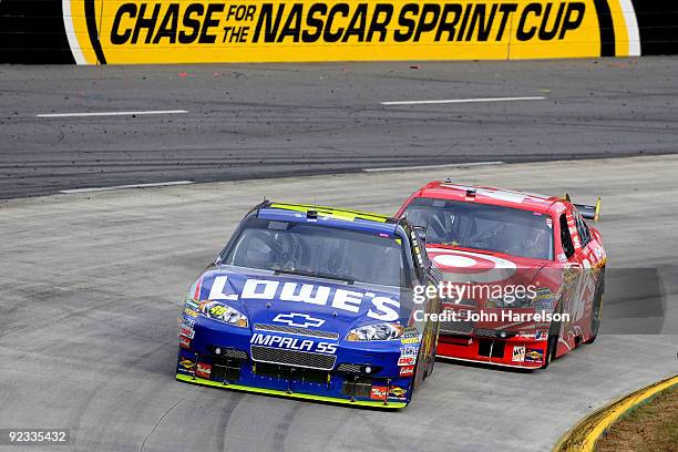 Jimmie Johnson, driver of the Lowe's Chevrolet, leads Juan Pablo Montoya, driver of the Target Chevrolet, during the NASCAR Sprint Cup Series TUMS...