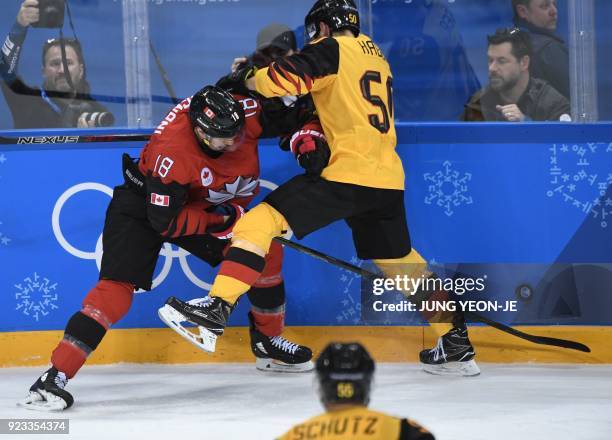 Canada's Marc-Andre Gragnani and Germany's Patrick Hager clash in the men's semi-final ice hockey match between Canada and Germany during the...