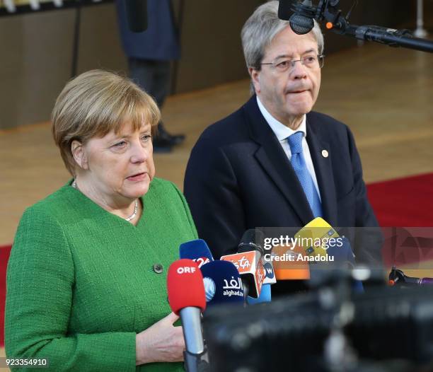 German Prime Minister Angela Merkel and Italian Prime Minister Paolo Gentiloni answer the questions of press members as they arrive to attend the EU...